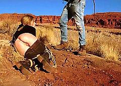 Big-butt blonde gets her anus whipped, then gets rough anal sex in dirt and piss -- a real BDSM session outdoors in the Western USA with Rebel Rhyder