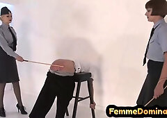 Uniformed bdsm mistresses caning their submissive in trio