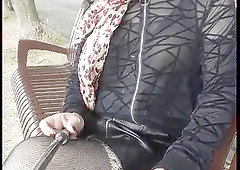 Sophie red-haired crossdresser ambles outside braless