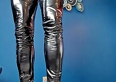 Teasing crossdresser in PVC leggings