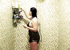 Wearing a short shiny club costume I let my hair down and step into the shower. The water cascades down my dressed body, soaking into the fabrics and 