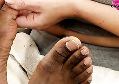 White woman gives ebony dude a pedicure