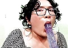 Transgender hotty playing with her throat with a sex-toy and masturbating her cock.