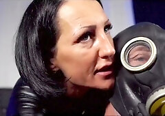 Tattooed German dominatrix in leather mask controls session with bound submissive