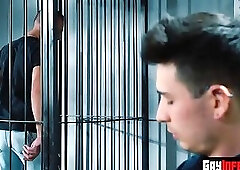 Prisoner pulling his jeans down for the officer on duty