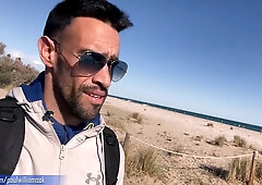 Sport young dude gets bare on Barcelona public beach after gym exercise