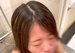 Asian woman in bathroom receives bukkake and golden shower on her face