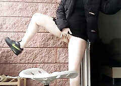 exhibitionist voids urine with twat lips open on a impure chair on balcony