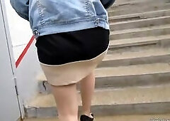 Girl in tan stockings going upstairs