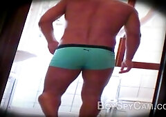 Buff guy flexing in the bathroom